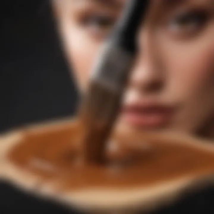 Close-up of a brush applying open coffee paint on a canvas