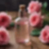 A close-up view of a bottle of rose water placed on a wooden table with fresh roses.